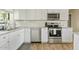 White kitchen cabinets, granite countertops, and stainless steel appliances at 730 W El Alba Way, Chandler, AZ 85225