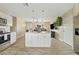 Open concept kitchen with island and view into living room at 730 W El Alba Way, Chandler, AZ 85225