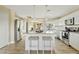 Modern kitchen with white cabinets, granite countertops, and stainless steel appliances at 730 W El Alba Way, Chandler, AZ 85225