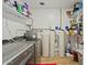 Laundry room with washer, dryer, water softener, and ample shelving at 730 W El Alba Way, Chandler, AZ 85225