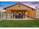 Covered patio with seating, fire pit, and string lights at 730 W El Alba Way, Chandler, AZ 85225