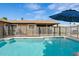 Sparkling pool with safety fence and patio umbrella at 730 W El Alba Way, Chandler, AZ 85225