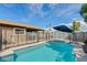 Inviting backyard pool with safety fence and patio umbrella at 730 W El Alba Way, Chandler, AZ 85225