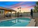 Inviting backyard oasis featuring a sparkling pool, covered patio, and lush landscaping at 730 W El Alba Way, Chandler, AZ 85225