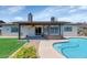 Large backyard with covered patio with ceiling fan and pool at 7331 W Aster Dr, Peoria, AZ 85381