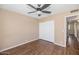 Bedroom with wood floors, closet, ceiling fan, and neutral paint at 7331 W Aster Dr, Peoria, AZ 85381