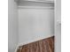Walk-in closet with hardwood flooring, clean white walls, and storage rack at 7331 W Aster Dr, Peoria, AZ 85381