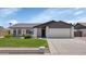 Charming single-story home features a well-maintained lawn, brick accents, and a two-car garage at 7331 W Aster Dr, Peoria, AZ 85381