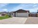 Single story home with brick accents, a spacious driveway, and a well-manicured lawn at 7331 W Aster Dr, Peoria, AZ 85381