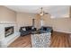 Inviting living room with wood floors, fireplace, vaulted ceilings and views into the kitchen at 7331 W Aster Dr, Peoria, AZ 85381