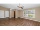 Bright living room with wood floors, large windows, vaulted ceilings and modern ceiling fan at 7331 W Aster Dr, Peoria, AZ 85381