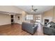 Open-concept living room with wood floors, fireplace, and seamless access to the kitchen at 7331 W Aster Dr, Peoria, AZ 85381