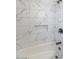 Updated shower with white marble-look tile and soap niche at 7331 W Aster Dr, Peoria, AZ 85381