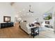 Open concept living room with hardwood floors, vaulted ceilings and fireplace at 7359 E Valley View Rd, Scottsdale, AZ 85250