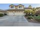 Traditional two-story home showcasing an attached three-car garage and a low-maintenance landscaped front yard at 745 E Kaibab Dr, Chandler, AZ 85249