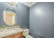 Charming powder room with granite countertop sink and decorative mirror at 745 E Kaibab Dr, Chandler, AZ 85249