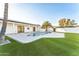 Lush backyard showcasing a modern pool, artificial grass, and a sleek, covered patio area at 7860 E Davenport Dr, Scottsdale, AZ 85260