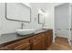 Bathroom with dual vessel sinks, wood cabinets and modern fixtures at 7860 E Davenport Dr, Scottsdale, AZ 85260