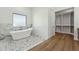 Modern bathroom features a soaking tub and a walk-in closet at 7860 E Davenport Dr, Scottsdale, AZ 85260