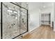 Glass enclosed shower and walk-in closet in this modern bathroom at 7860 E Davenport Dr, Scottsdale, AZ 85260