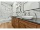 Modern bathroom features dual vessel sinks, wood cabinets and marble accent wall at 7860 E Davenport Dr, Scottsdale, AZ 85260
