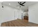 Bright bedroom features wood floors, modern ceiling fan, and an ensuite bathroom at 7860 E Davenport Dr, Scottsdale, AZ 85260
