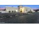 Elegant exterior view of a modern home with a well-manicured stone front yard and a paved driveway at 7860 E Davenport Dr, Scottsdale, AZ 85260