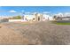 Wide exterior view highlighting the house's modern design, extensive paved driveway, and manicured landscaping at 7860 E Davenport Dr, Scottsdale, AZ 85260