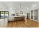 Modern kitchen featuring stainless steel appliances, sleek cabinetry, and stylish hardwood flooring at 7860 E Davenport Dr, Scottsdale, AZ 85260