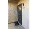 Condo building entry with a black security door and a welcome mat at 7910 E Thomas Rd # 121, Scottsdale, AZ 85251