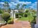 Lush backyard with manicured landscaping, palm trees, and a view of the lake at 10120 E Topaz Dr, Scottsdale, AZ 85258