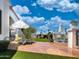 Expansive backyard with stone patio, artificial lawn and seating areas overlooks the waterfront at 10120 E Topaz Dr, Scottsdale, AZ 85258
