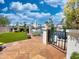 Charming backyard patio with a dining set, green lawn, and stunning waterfront view at 10120 E Topaz Dr, Scottsdale, AZ 85258