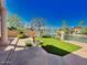 Waterfront backyard with a grassy lawn and fountain at 10120 E Topaz Dr, Scottsdale, AZ 85258