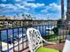 Balcony view featuring wrought iron railing overlooking a waterfront and boat slip at 10120 E Topaz Dr, Scottsdale, AZ 85258