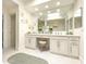 Bright bathroom with double sinks, vanity area, large mirror, modern lighting, and hexagon tiled floors at 10120 E Topaz Dr, Scottsdale, AZ 85258