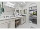 Bright bathroom featuring double sinks, vanity area, and view into the bedroom at 10120 E Topaz Dr, Scottsdale, AZ 85258