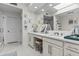 Bathroom with double sinks, a large mirror and access to a walk in shower at 10120 E Topaz Dr, Scottsdale, AZ 85258