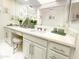 Bright bathroom featuring double vanity, marble countertops, white cabinetry and ample counter space at 10120 E Topaz Dr, Scottsdale, AZ 85258