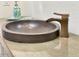 Chic bathroom features a concrete vessel sink and bronze faucet at 10120 E Topaz Dr, Scottsdale, AZ 85258