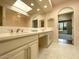 Bright bathroom boasts double sinks, skylight, and view into bedroom at 10120 E Topaz Dr, Scottsdale, AZ 85258