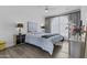 Inviting bedroom with a ceiling fan, dark furniture, and bright natural light from a large window at 10120 E Topaz Dr, Scottsdale, AZ 85258
