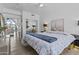Bright bedroom with wood floors, ceiling fan, and view to the living room at 10120 E Topaz Dr, Scottsdale, AZ 85258