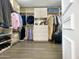 Organized walk-in closet with custom shelving, drawers, and ample space for clothing storage at 10120 E Topaz Dr, Scottsdale, AZ 85258