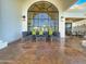 Inviting covered patio with stone flooring, comfortable seating, and a beautiful lake view at 10120 E Topaz Dr, Scottsdale, AZ 85258