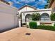 Charming home exterior with arched windows, well-manicured landscaping, and private gated entry at 10120 E Topaz Dr, Scottsdale, AZ 85258