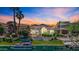 Stunning waterfront home with lush landscaping, private dock, and sunset views at 10120 E Topaz Dr, Scottsdale, AZ 85258