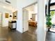 Foyer with hardwood floors, leading to bedroom, showcasing front door with black frame at 10120 E Topaz Dr, Scottsdale, AZ 85258