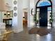 Foyer featuring a decorative front door, hardwood floors, and access to bedroom at 10120 E Topaz Dr, Scottsdale, AZ 85258