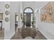 Grand foyer featuring high ceilings, elegant decor, and an eye-catching animal print rug on hardwood floors at 10120 E Topaz Dr, Scottsdale, AZ 85258